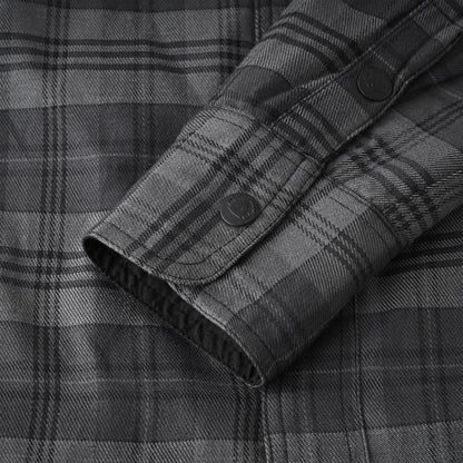 Close-up of a dark gray and black plaid button-down shirt showing the fabric texture and cuff detail.